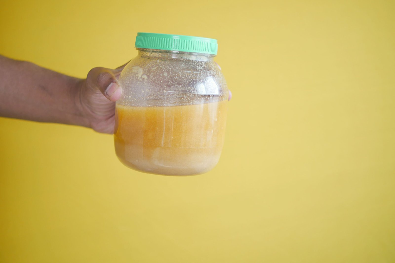 homemade-ghee-in-container-against-yellow-background-kindorus homemade-ghee-in-container-against-yellow-background-kindorus